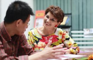 Photo of a student talking to a teacher